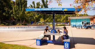 Students charge their devices at the solar charging table outside of the Student Center.