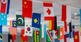 Flags from around the world hang from a classroom ceiling