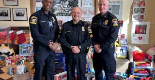 CCSU Police officers pose with toy donations in the campus police department lobby.