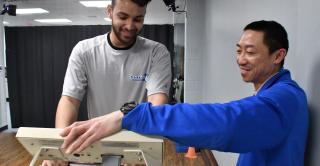 A student athlete and Athletic Training faculty member work together on a treadmill.