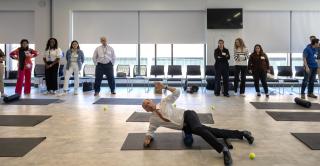 Mike Ryan demonstrates a foam roller exercise at Barnard Hall.