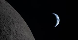 Earth draws closer to passing behind the Moon in this image captured by the Artemis II crew during their lunar flyby, about six minutes before Earthset. Earth is in a crescent phase, with sunlight coming from the right. (Image courtesy of NASA)