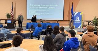 Students sit in Alumni Hall listening to a presenter during the 19th annual sustainability symposium at Central.