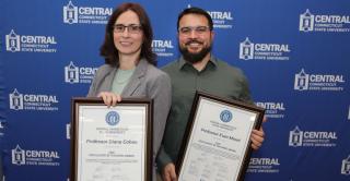 EIT winners Dr. Diana Cohen (Political Science) and Evan Morel ’14 (Engineering) stand against a Central branded backdrop.