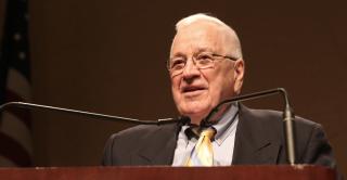 Richard Judd speaks behind a podium