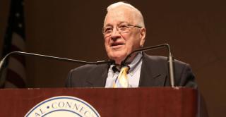Richard Judd speaks behind a podium