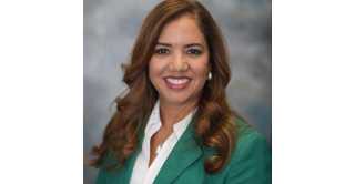 Portrait of Dr. Joann Leon in a green jacket