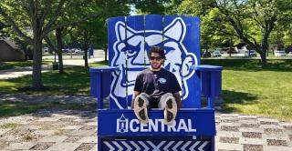 Exchange student Zakaria Butt settles in on the Central campus. He is shown here in the big blue chair outside of the Student Center.