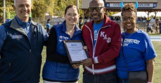 Central COO Sal Cintorino, Interim President Kimberly Kostelis, Larry Hall, and Persephone Hall are shown here on the football field at Central.