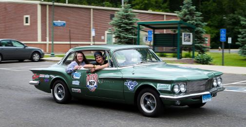 Central Students riding in a green 1961 Dodge Lancer