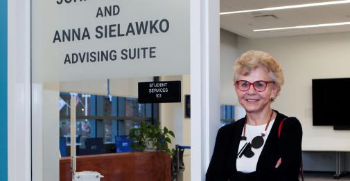 Sielawko posing in front of the Eismont and Sielawko advising suite