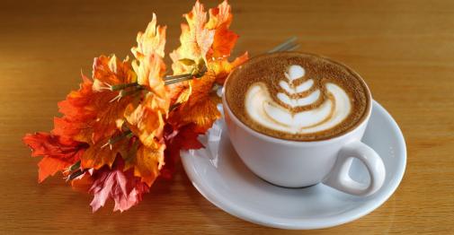 Cup of cofee positioned with fall leaves