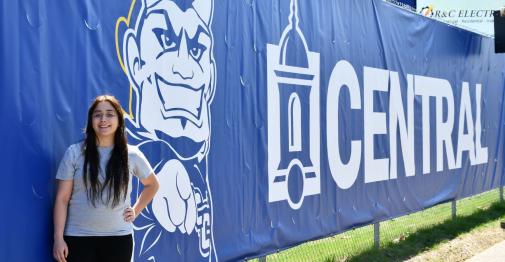Emily Ramirez stands in front of her scrim design