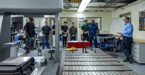 Apprenticeship program students gather in a robotics lab in the Applied Innovation Hub.