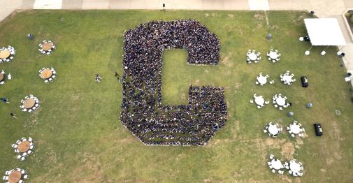 Drone photo of students in the shape of a C on Vance lawn.