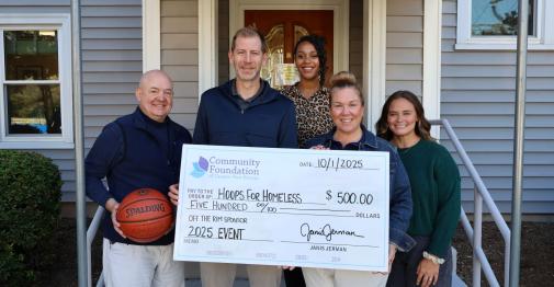 Hoops for Homeless founders hold up a ceremonial donation check