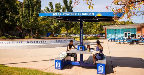 Students charge their devices at the solar charging table outside of the Student Center.