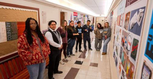 Students, joined by Professor Wujun Wang and Administrator Kevin Rivera, share their portfolios with family and friends during a recent showcase.