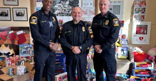 CCSU Police officers pose with toy donations in the campus police department lobby.