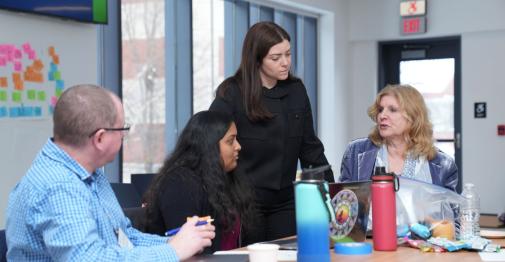 CSCU educators talk in a meeting room at Central 