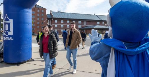Guests approach a branded banner at Accepted Students Day on March 28.