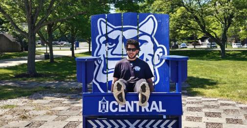 Exchange student Zakaria Butt settles in on the Central campus. He is shown here in the big blue chair outside of the Student Center.
