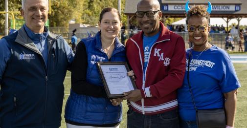 Central COO Sal Cintorino, Interim President Kimberly Kostelis, Larry Hall, and Persephone Hall are shown here on the football field at Central.