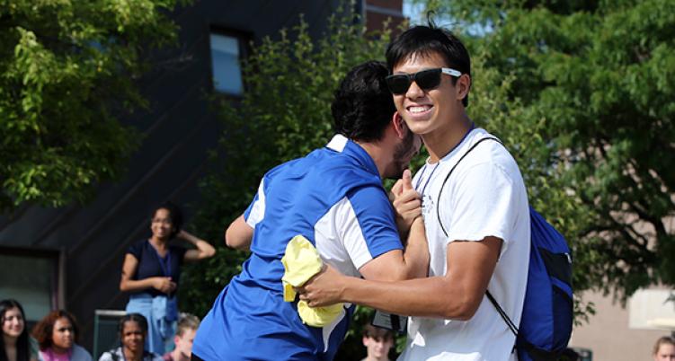 Two Student hug in student center circle