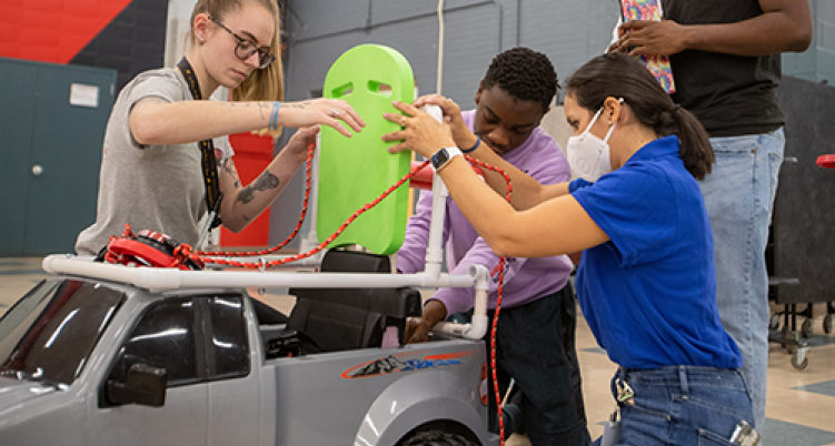 ccsu students working on a child go-cart