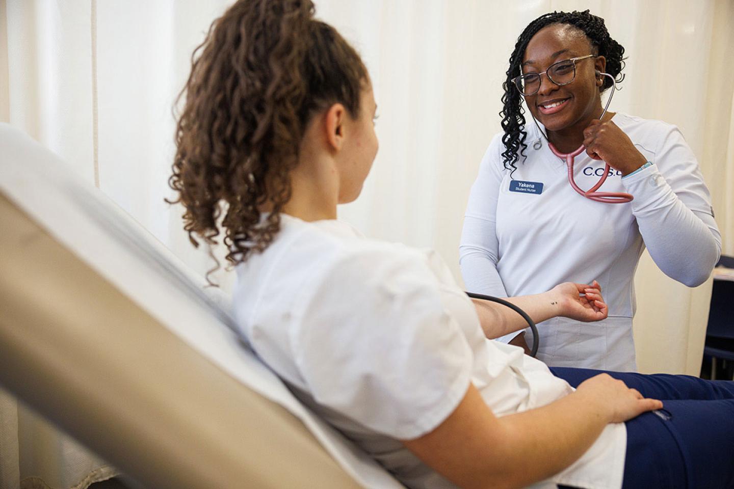 Nursing students taking vitals
