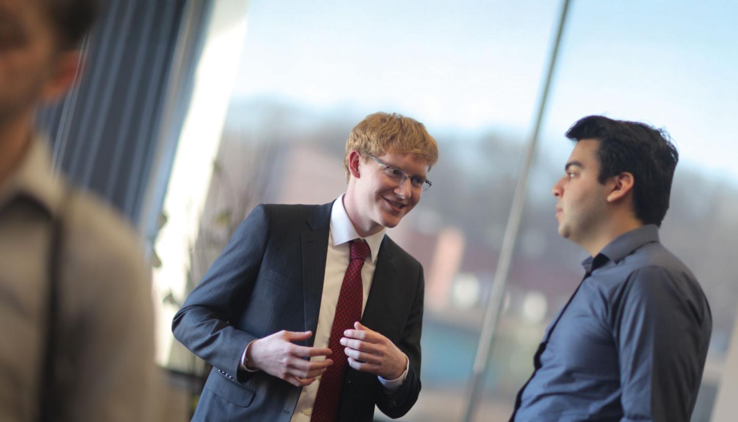 Students in suits talking business