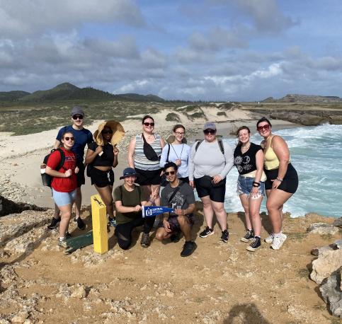 Students standing in front of beach  