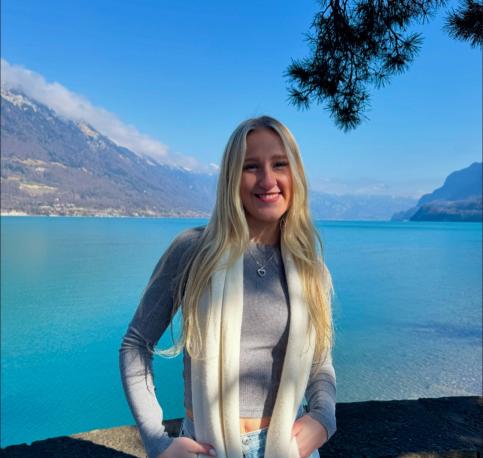 Blonde woman in front of a lake 
