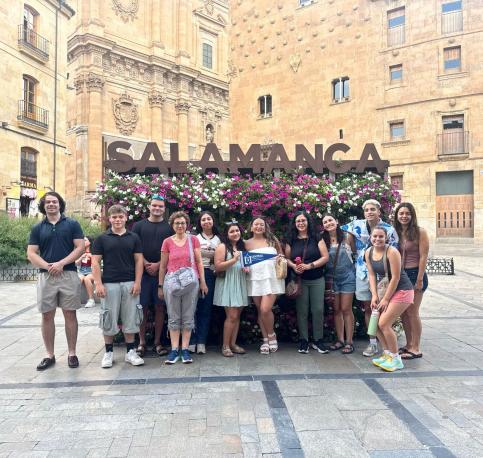 Students posing in front of Salamanca Sign in Spain