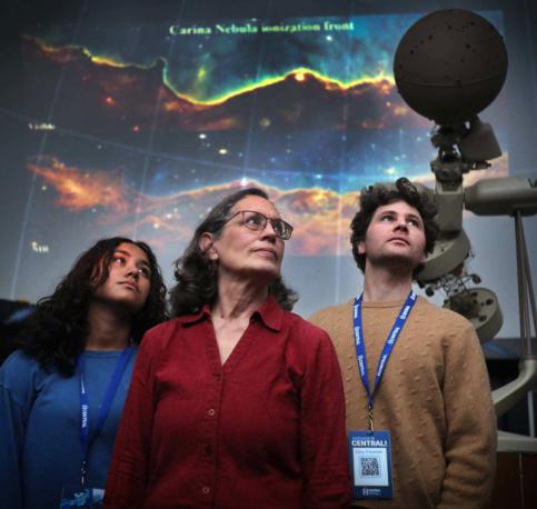 students and teacher in planetarium