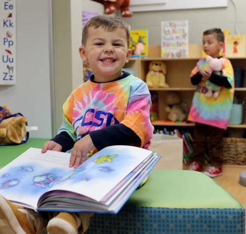 two young children reading a book